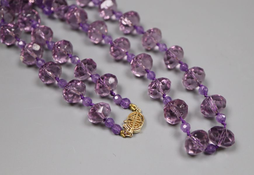 A single strand facetted purple paste bead necklace with 14k yellow metal clasp, 53cm.